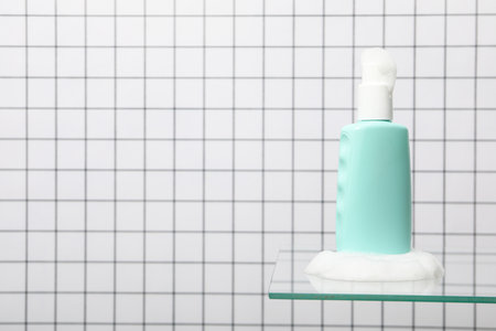 A bottle with a care product in foam.の写真素材