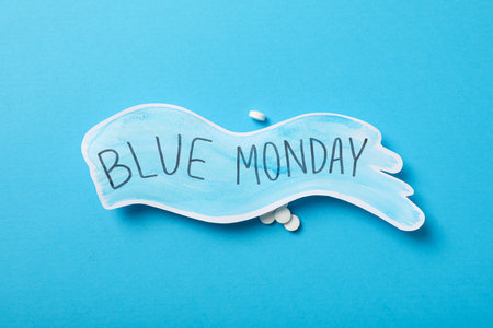 Blue Monday text and pills on blue background, top viewの写真素材