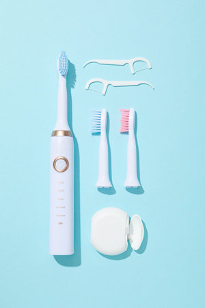 Electric toothbrushes on blue background, top viewの写真素材