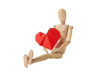 PNG, paper heart in the hands of a wooden doll. Blood donation isolated on white backgroundの写真素材