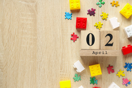 Multicolored puzzle pieces and legos on a light background, place for text. world autism day concept