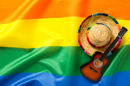 Guitar and sombrero on the background of the lgbt flag.の写真素材