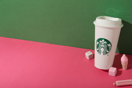 Ukraine, Kyiv, 24/08/2023: Starbucks coffee cup with logo, with joystick.