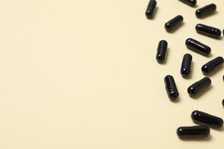 Tablets of activated carbon on a light background