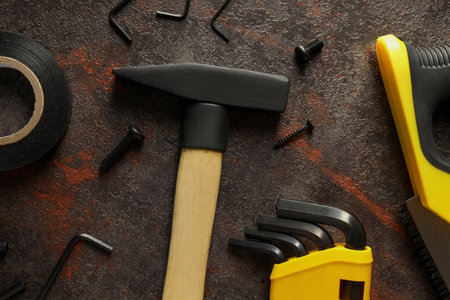 Construction tools on dark background, top view