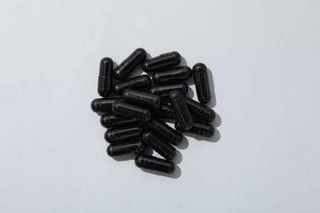 Tablets of activated carbon on a white backgroundの写真素材