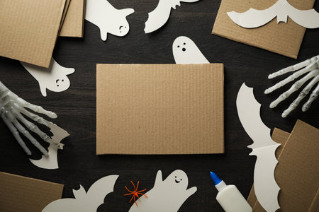 Paper ghosts and bats, cardboard on wooden background, space for textの写真素材