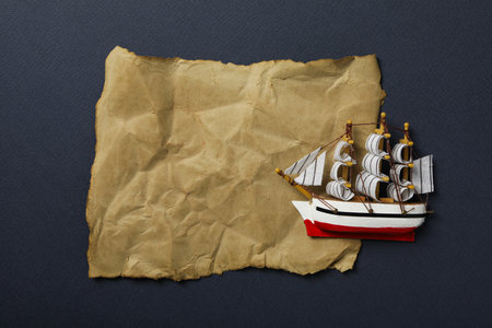 Columbus day. Toy ship with an old sheet of paper