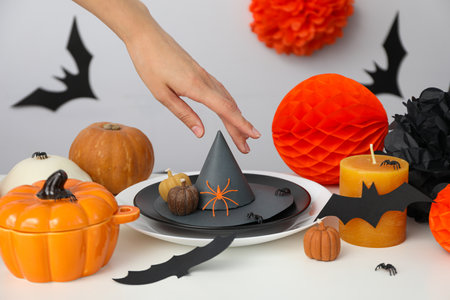 Spooky holiday table decorations with bats and pumpkins for Halloween