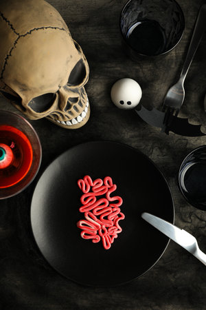 Spooky holiday table decorations with a skull for Halloweenの写真素材