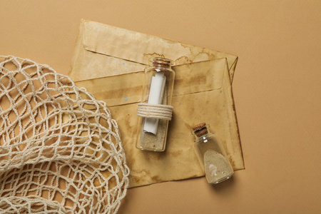 Columbus day. Old envelopes and a glass bottle with a letter insideの写真素材