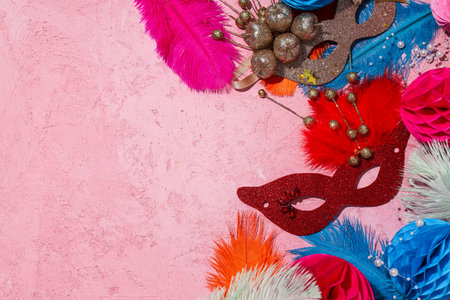 Carnival masks and feathers on pink background, space for textの写真素材