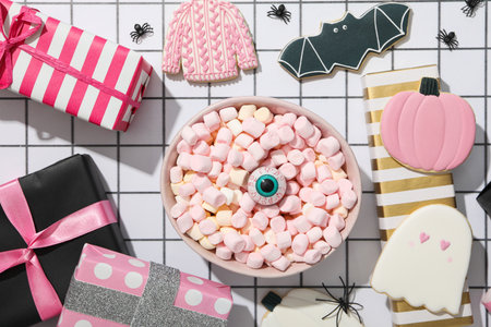 Cookies, marshmallows and brightly colored gifts for Halloweenの写真素材