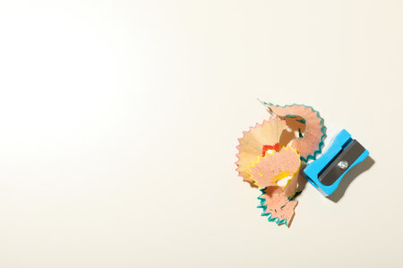 Pencil sharpener with shavings on a light background.の写真素材