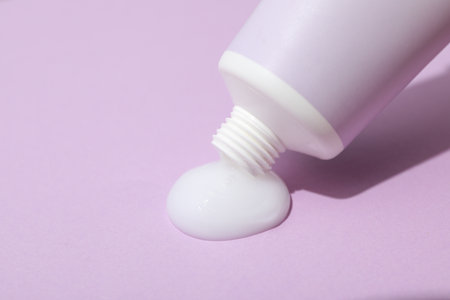 Tube with cream on purple background, close upの写真素材