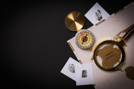 Magnifying glass with map and vintage compass