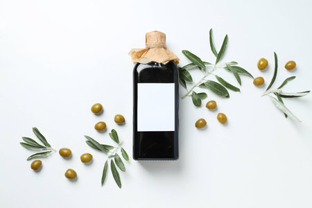 Olive oil bottle and olives on white background, top viewの写真素材