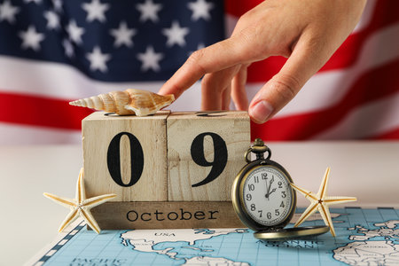 Columbus Day. Calendar with a clock on the background of the American flagの写真素材