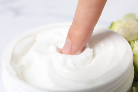 A jar of hand cream, close-up, on a light background.の写真素材