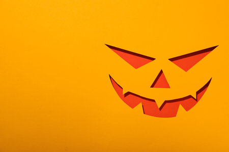 Paper eyes and mouth on yellow background, space for text