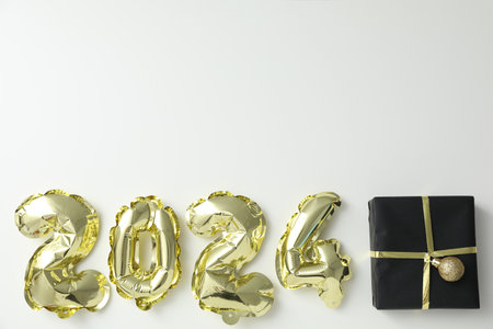 New Year 2024 with golden balloons with giftsの写真素材