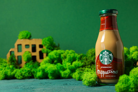 Ukraine, Kyiv, 08/24/2023: Starbucks frappuccino bottle with logo, on a moss background.のeditorial素材