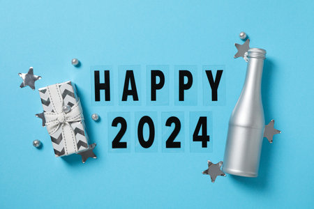 The concept of celebrating the New Year 2024, a gift with a bottleの写真素材