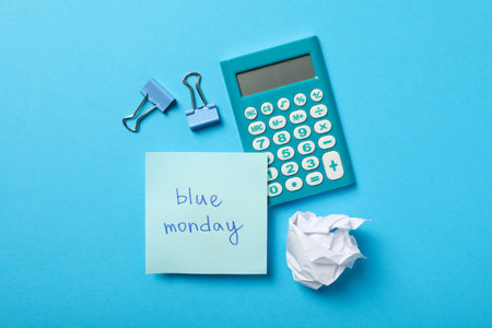 Calculator, note, paper and binders on blue background, top viewの写真素材