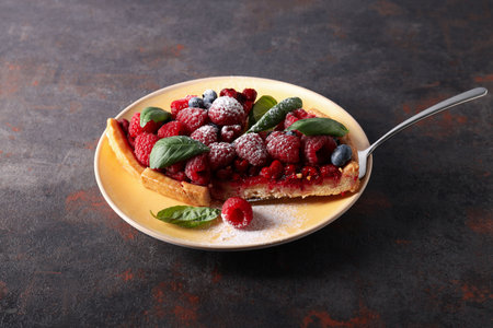 Two pieces of berry pie on plate on gray background, close upの写真素材
