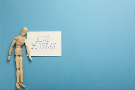 Paper with text Blue Monday and wooden man on blue background, space for textの写真素材