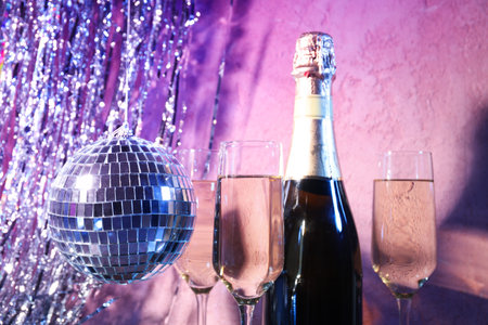 Disco ball with a bottle of shaman and glassesの写真素材