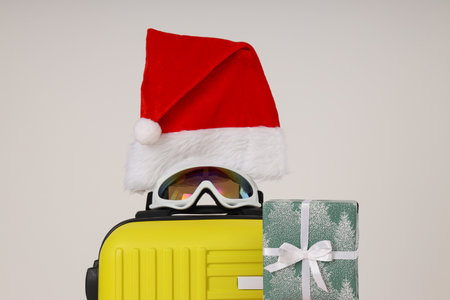 A suitcase with a New Year's hat, glasses and giftsの写真素材