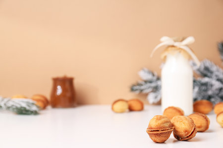 Nut cookies with a bottle of milk and a Christmas tree branchの写真素材