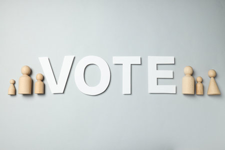 Wooden figures and word Vote on gray background, top viewの写真素材