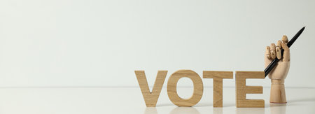 Wooden letters and hand with pen on white background, space for textの写真素材