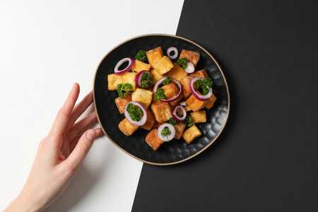 Fried tofu in a bowl on a black and white backgroundの写真素材