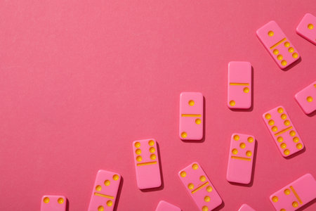 Pink dominoes on pink background, space for text