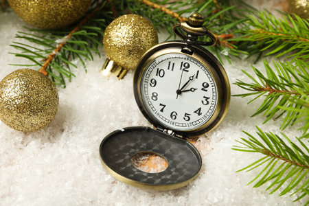 Pocket watch with snow on a light background.の写真素材
