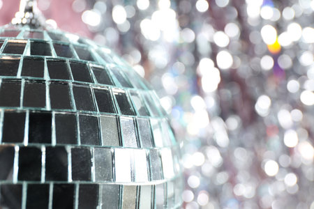 Disco ball reflects light on a pink background