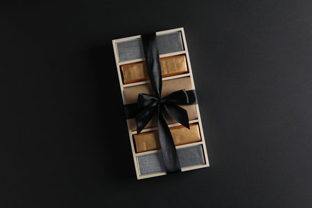 Chocolate bars in a gift box on a dark background