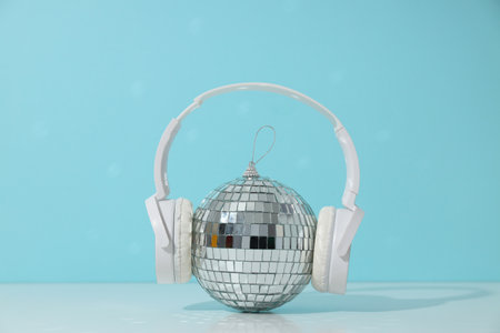 A beautiful disco ball with headphones on a blue background