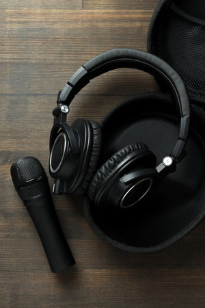 Black, large headphones, on the table with a microphone.の写真素材