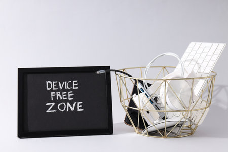 Digital detox written with gadgets on a black board.