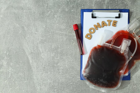 A package with donor blood and papers on the tableの写真素材
