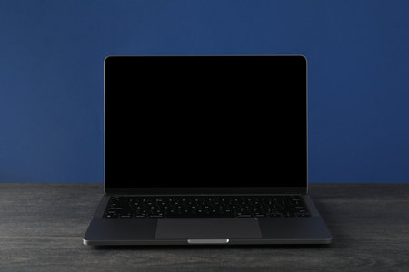 An open laptop on a dark tableの写真素材