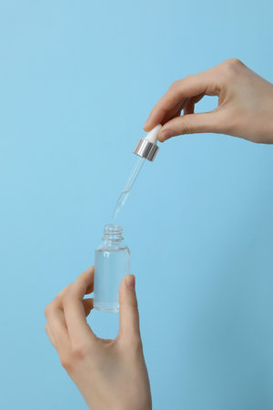 Hyaluronic acid serum on a blue background.の写真素材