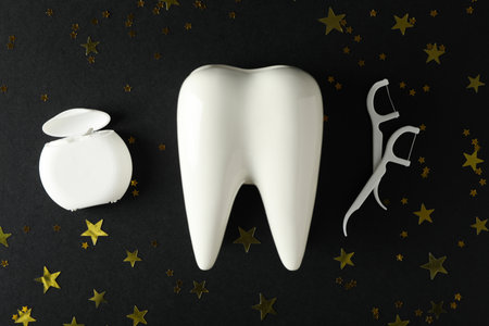 Teeth with festive stars, on a dark background.の写真素材