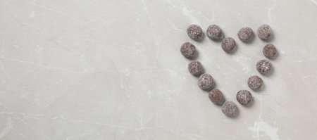 A heart made of sweet candies on a light background.