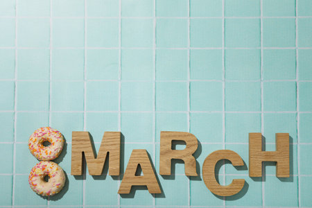 The number eight is made of two donuts and the inscription Marchの写真素材