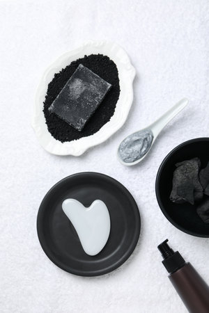 Set of cosmetics with charcoal on a light background.の写真素材